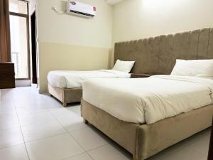 Tempat tidur dalam kamar di Bella Vista Hotel Apartments
