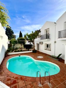 a swimming pool in front of a house at VILLA MERCEDES in Granada