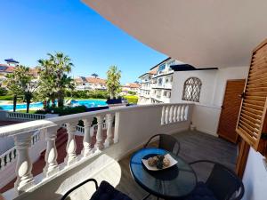 a balcony with a table and chairs and a pool at Parquemar in La Mata