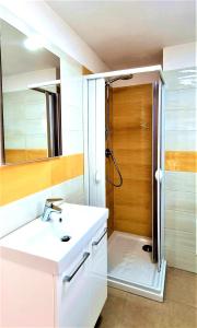 a bathroom with a white sink and a shower at La bella costiera monolocale in Sant'Egidio del Monte Albino