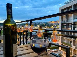 a bottle of wine and a wine glass on a balcony at Apartamento Ecléctico Budapest in Budapest