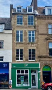 a man standing in front of a building at Number 6 Crossgate in Fife