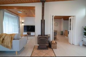 a living room with a couch and a wood stove at Yasar farm stay Marshall view 