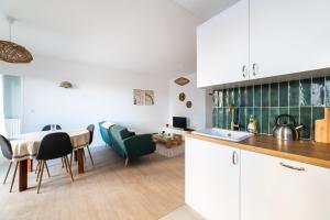 uma cozinha e sala de estar com mesa e cadeiras em Appartement rénové Proche Paris - 5 min transport em Montrouge
