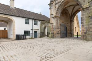 an entrance to a building with a stone courtyard at Lightfoot Cottage in Bishop Auckland