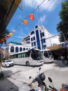 a white bus parked in front of a building at SALA HOTEL HUE in Hue