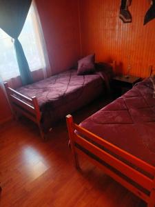 Postel nebo postele na pokoji v ubytování Cabaña el ricky