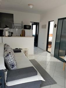a living room with a couch and a kitchen at Apartments Frigan in Maslenica