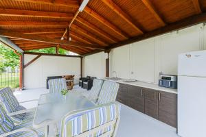 a patio with a table and chairs and a refrigerator at The Blue House in Leptokarya