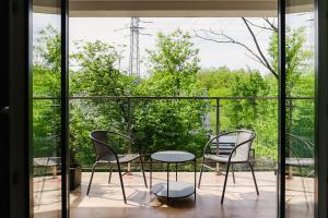 un patio con 2 sillas y una mesa en el balcón en Strumienna Apartament, en Cracovia