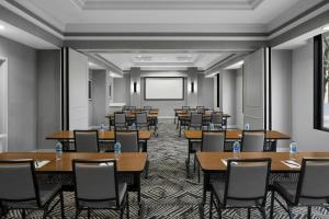 a conference room with tables and chairs and a projection screen at Hyatt Place Denver Cherry Creek in Denver