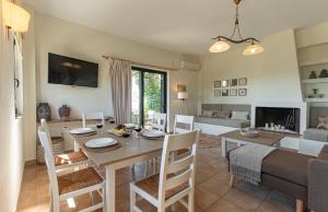 a dining room and living room with a table and chairs at Terra Calma Residence in Karistos