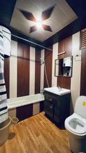 a bathroom with a toilet and a sink at Heritage Houseboats Kashmir in Srinagar