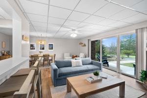 a living room with a couch and a table at New Lake View Retreat Pool 4min to Beach in Lake Geneva