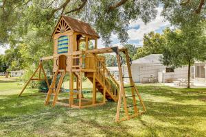 a wooden playground with a tower and a slide at Valrico Vacation Rental about 10 Mi to Dinosaur World! in Valrico