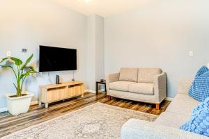 a living room with a tv and a couch and a chair at Home Near Downtown and Lucas Oil Stadium! in Indianapolis