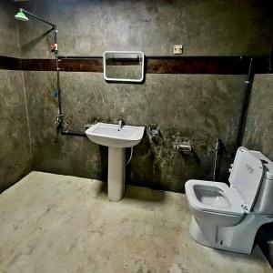 a bathroom with a toilet and a sink at Hotel City Light Budget in Colombo