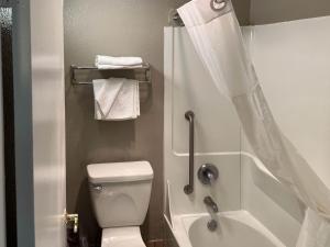 a small bathroom with a toilet and a shower at Motel 6 Portland OR Southeast in Portland