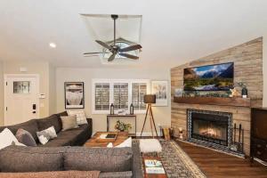 a living room with a couch and a fireplace at Fitzy's Fir Lodge - Fun For the Whole Family, Dogs Welcome, Jacuzzi Tub in Sugarloaf