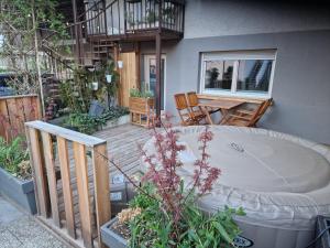 a patio with a table and chairs on a deck at Studio Bizjak in Vrhnika