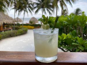 a drink sitting on a table next to a resort at St. George's Caye Resort in Ladyville