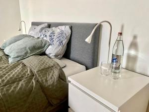 a bedroom with a bed and a table with a bottle on it at Cosy Room in Remich in Remich