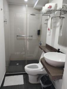 a bathroom with a toilet and a sink and a shower at Puertas de San Antonio in Cali