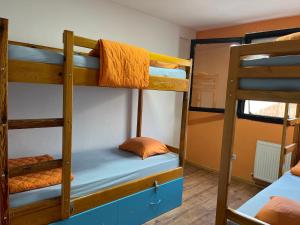 a room with three bunk beds in a hostel at Blue Orange Lake Hostel in Ohrid
