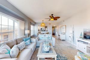 a living room with a couch and a table at Sunset Sea Villa in Clearwater Beach