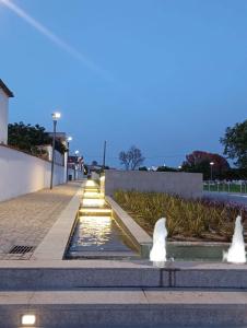 a fountain with two fountains on a sidewalk at Hospedaria São João in Vidigueira +24 photos