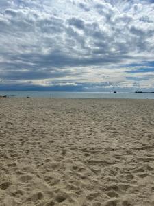 an empty beach with footprints in the sand at Hotel San Marco in Savona