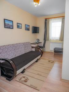 a living room with a bed and a desk at Оаза in Dragobrat