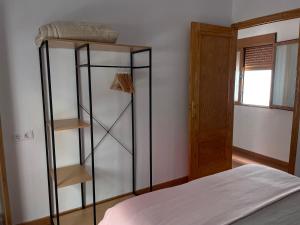 a bedroom with a bed and a book shelf at El Mercado in Alcaudete +28 photos