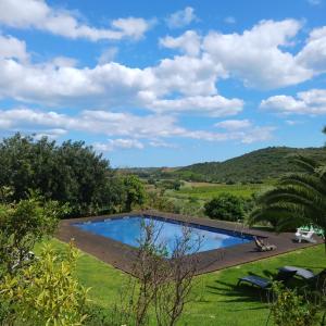 a swimming pool in the yard of a house at Casa da Osga in Tavira