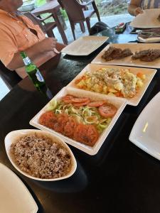 a table with plates of food on a table at Villa Las Mellizas in Puerto Armuelles +35 photos