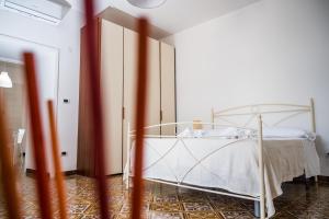 a bedroom with a bed with a white bed frame at Terrazza Mediterranea in Vietri sul Mare