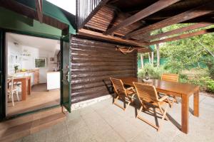 an outdoor dining room with a wooden table and chairs at Tiny house Laurel in Kostrena