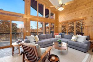 a living room with a couch and a table at Kindred Hollow-Lake & Mountain Views in Rogers