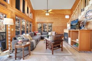 a living room with a couch and a table at Kindred Hollow-Lake & Mountain Views in Rogers