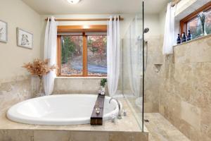 a large bathroom with a tub and a window at Kindred Hollow-Lake & Mountain Views in Rogers +35 photos