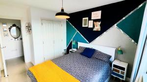 a bedroom with a bed and a black and white wall at La Casita, Your Home Away from Home - Free Parking in Glasgow