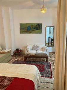 a living room with a couch and a mirror at Bab El Fen in Tangier