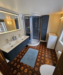 a bathroom with two sinks and a shower at Private pearl in downtown Røros in Røros