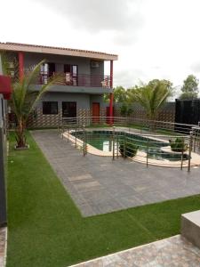 uma casa com piscina em frente a uma casa em Résidence BANA em Ngaparou