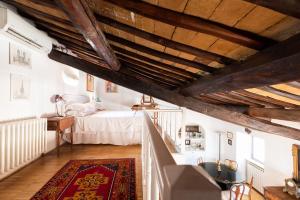 a bedroom with a bed and a wooden ceiling at Farnese Stunning Penthouse | Romeloft in Rome