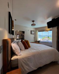 a bedroom with a large bed with a couch at Hotel Garni Cruzeiro do Sul in Trindade +101 photos