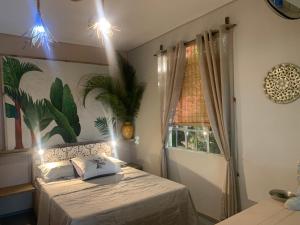 a bedroom with a bed and a window at Palms Ocean views in Rodrigues Island