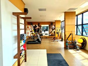 a gym with treadmills and exercise equipment in a building at Royal Duplex Umarizal in Belém
