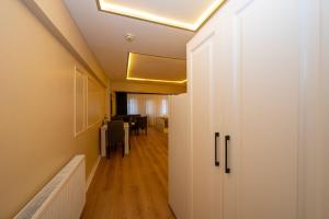 a hallway with a door and a dining room at Aiza Suites in Istanbul