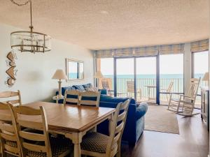 默特尔比奇The Blue Dune Oceanfront Huge Balcony w Lazy River的客厅里有一张蓝色的沙发和一张桌子